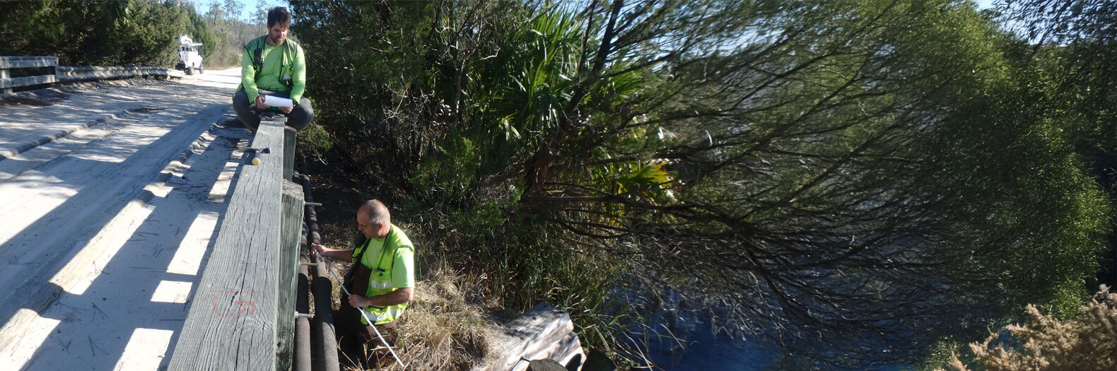 2 men inspecting a bridge